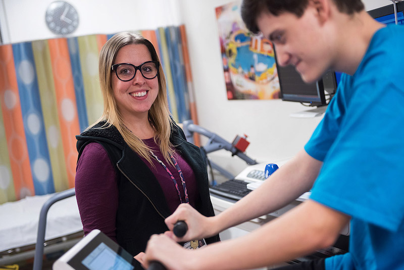 A clinician supports a young patient in Boston Children’s Cardiac Fitness Program